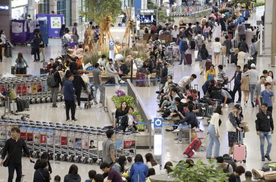 [디지털타임스 김아름 기자] 정부가 추석 연휴 이후 '입국장 면세점' 도입 방안을 내놓기로 한데 대해 업계와 소비자의 반응이 엇갈리고 있다. 추석 연휴 마지막 날인 26일 오전 인천국제공항 1터미널 입국장이 붐비고 있다. 연합뉴스